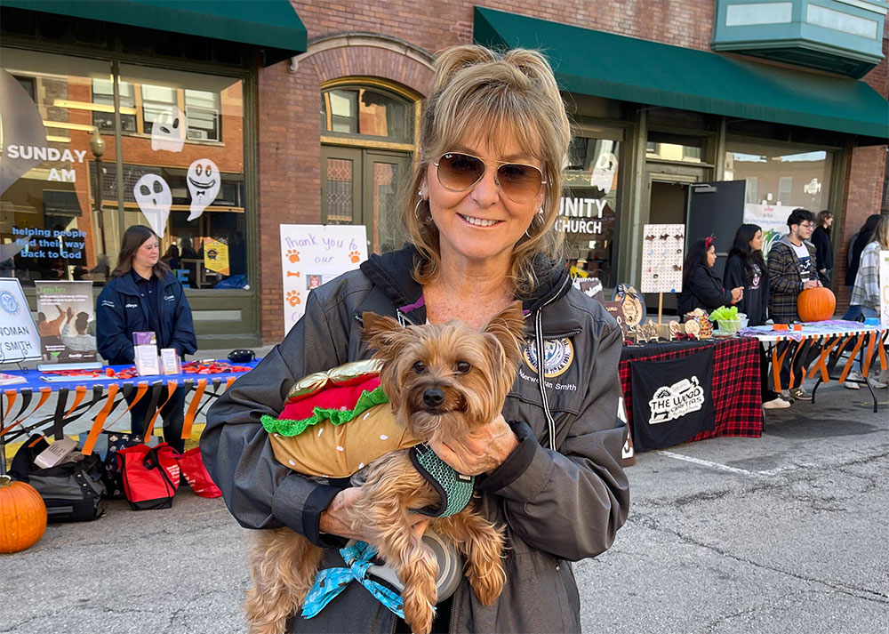 Patty Smith holding Tucker, her dog, at a community event in Aurora's 8th Ward