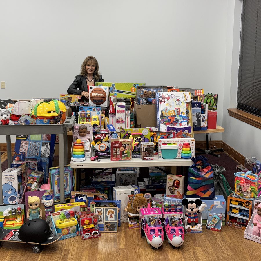 Patty Smith behind tables piled with donated toys